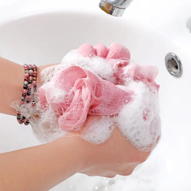 Large Japanese bath towel and exfoliating bath ball for gentle cleansing and spa-like relaxation in soft, absorbent materials.