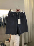 Light blue loose casual women's five-point denim shorts with rolled hems, showcasing a relaxed fit and five-pocket style.