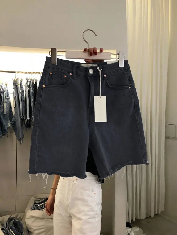 Light blue loose casual women's five-point denim shorts with rolled hems, showcasing a relaxed fit and five-pocket style.