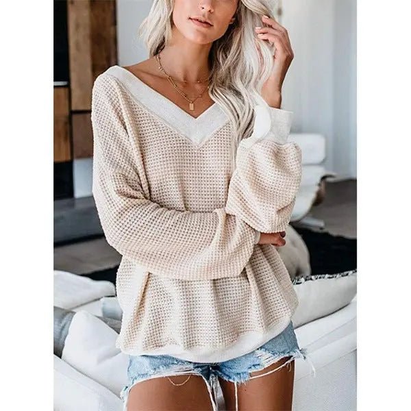 Loose V-neck knit sweater with plaid design, featuring a cozy fit and stylish pattern, perfect for casual wear.