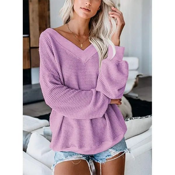 Loose V-neck knit sweater with plaid design, featuring a relaxed fit and cozy fabric, perfect for casual fall and winter wear.
