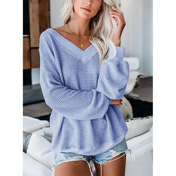 Soft loose V-neck knit sweater with plaid pattern, featuring a relaxed fit and cozy fabric, perfect for casual wear.