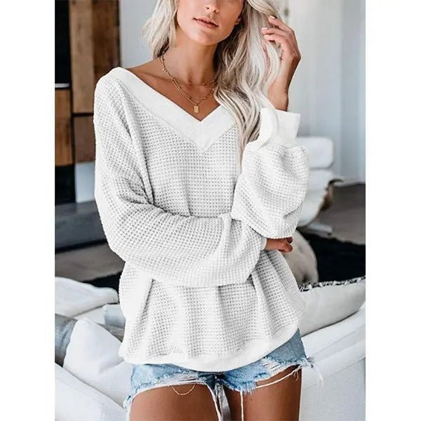 Loose V-neck knit sweater with plaid pattern, featuring a relaxed fit and casual style, perfect for cozy fall outfits.