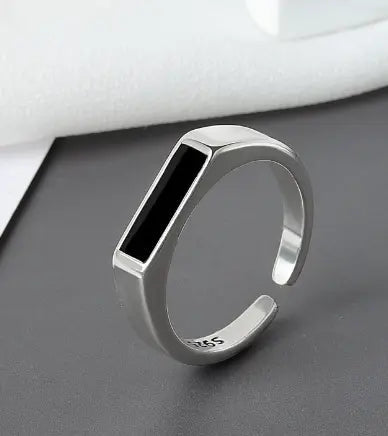 Sterling silver black ring featuring a cool wind-inspired design, showcasing intricate craftsmanship and unique style.