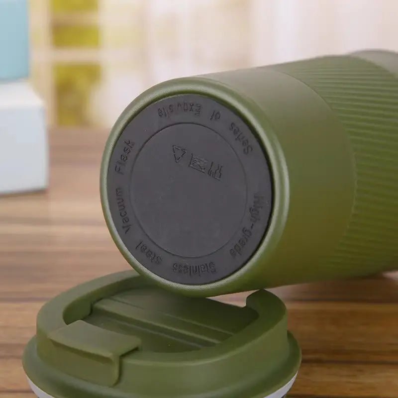 Stainless steel vacuum insulated travel mug with lid, designed for hot and cold beverages on the go.