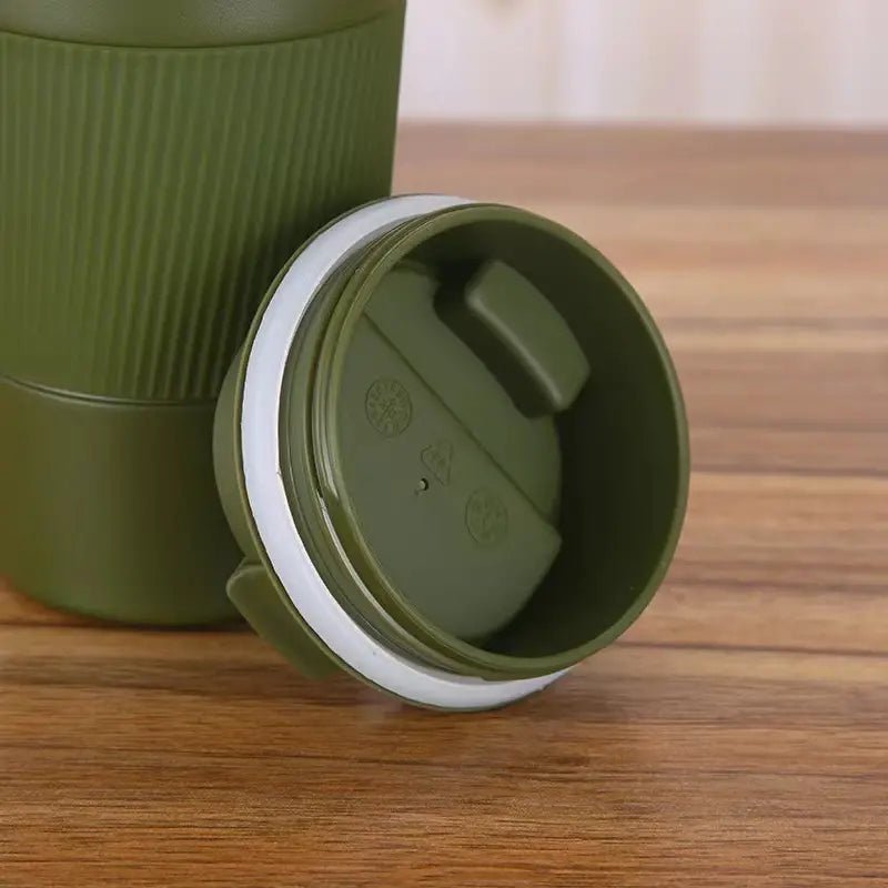 Stainless steel vacuum insulated travel mug with lid, designed for hot and cold beverages, featuring a sleek, modern appearance.
